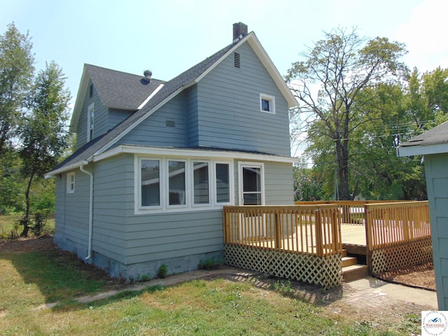 311 N Water St, Clinton, MO 64735 - back of property with a chimney, a wooden deck, and a shingled roof