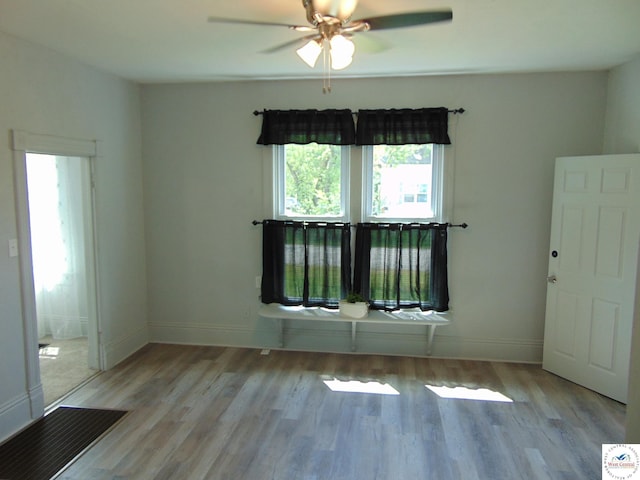 311 N Water St, Clinton, MO 64735 - empty room featuring baseboards, wood finished floors, and a ceiling fan