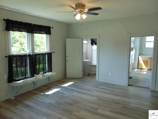 311 N Water St, Clinton, MO 64735 - unfurnished bedroom with baseboards, visible vents, wood finished floors, and ceiling fan