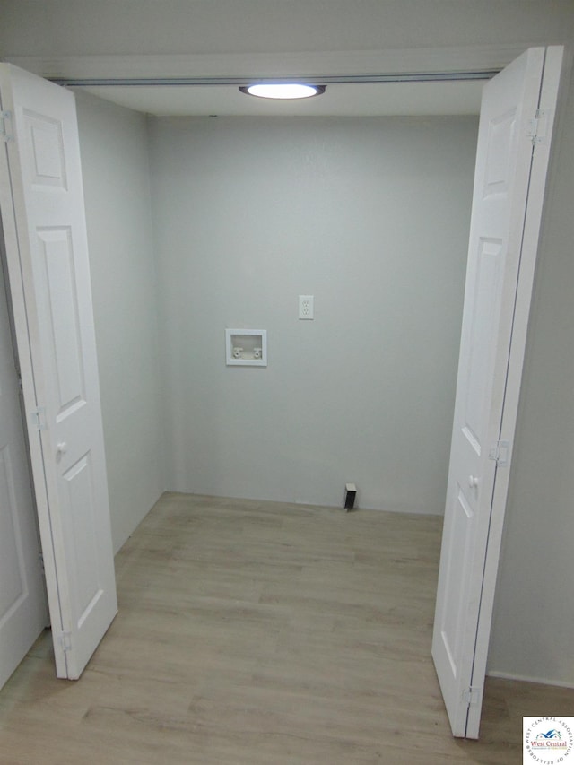 311 N Water St, Clinton, MO 64735 - clothes washing area with washer hookup, laundry area, and light wood finished floors
