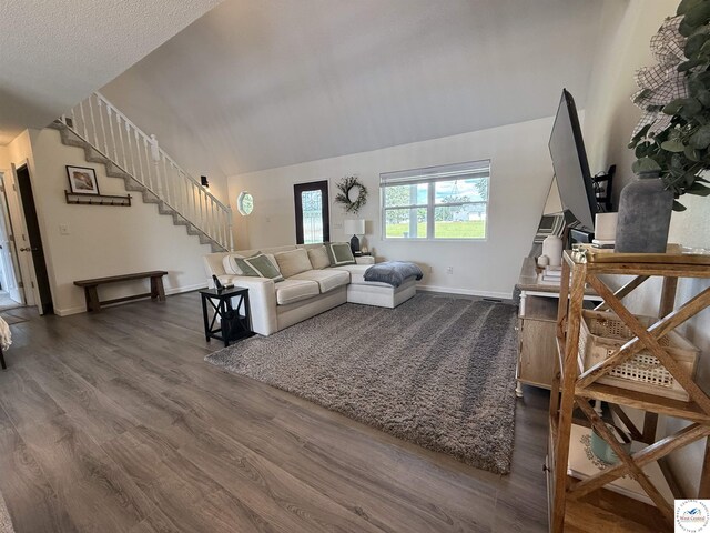 225 Crescent Dr, Lincoln, MO 65338 - living room featuring dark wood finished floors, stairway, and lofted ceiling