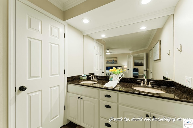 ensuite bathroom with double vanity, ensuite bathroom, ornamental molding, and a sink
