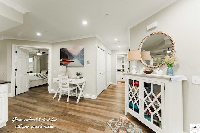 hallway with ornamental molding, light wood finished floors, and recessed lighting