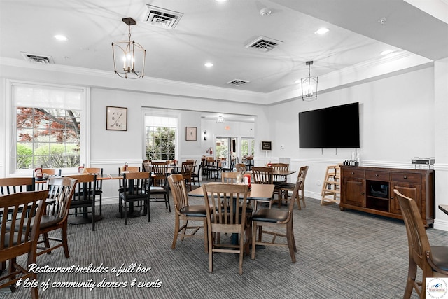 carpeted dining space with crown molding and visible vents