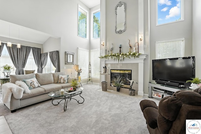 414 S Borgman Rd, Buckner, MO 64016 - living room featuring a towering ceiling, plenty of natural light, a tile fireplace, and carpet flooring