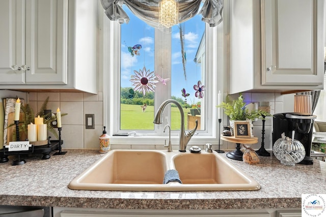 414 S Borgman Rd, Buckner, MO 64016 - kitchen view of white cabinets, tasteful backsplash, and light countertops