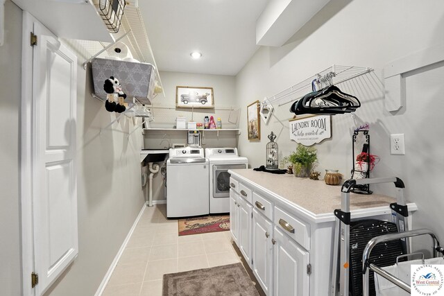 414 S Borgman Rd, Buckner, MO 64016 - laundry room featuring washing machine and dryer, cabinet space, and light tile patterned flooring