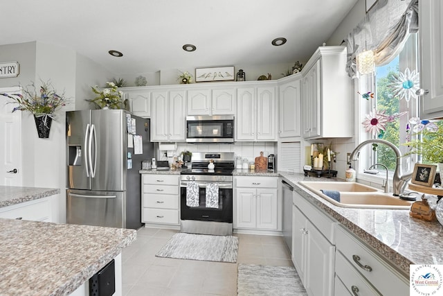 414 S Borgman Rd, Buckner, MO 64016 - kitchen with stainless steel appliances, decorative backsplash, and light tile patterned flooring