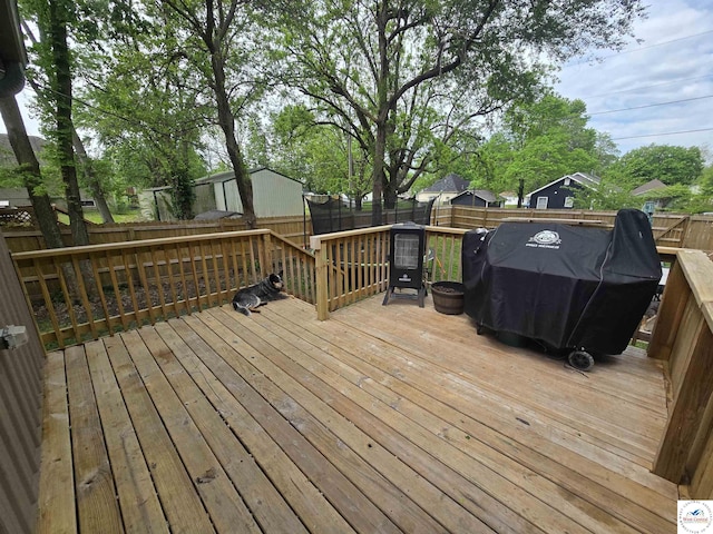 1824 S Grand Ave, Sedalia, MO 65301 - wooden deck featuring a grill and a fenced backyard