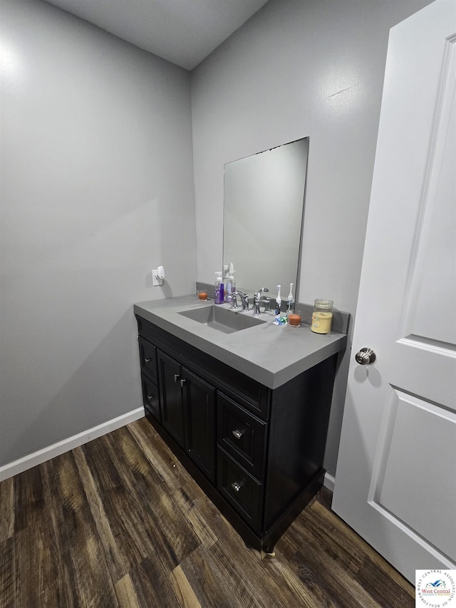1824 S Grand Ave, Sedalia, MO 65301 - bathroom featuring wood finished floors and vanity