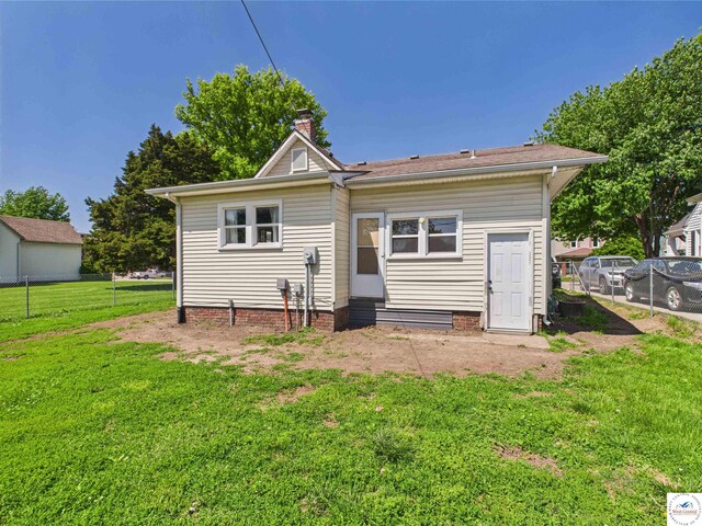 1407 E Main St, Higginsville, MO 64037 - rear view of house featuring entry steps and a chimney