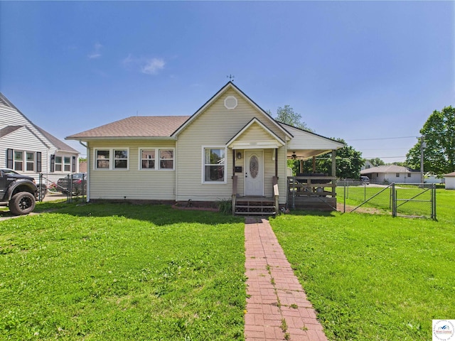 1407 E Main St, Higginsville, MO 64037 - view of front facade with a porch, a gate, a ceiling fan, and a shingled roof