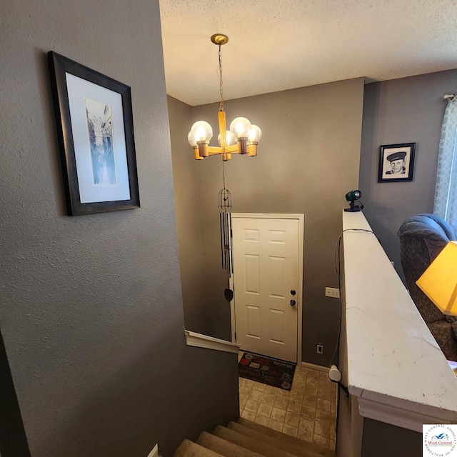 2206 N Swisher Dr, Clinton, MO 64735 - staircase featuring a chandelier and a textured wall