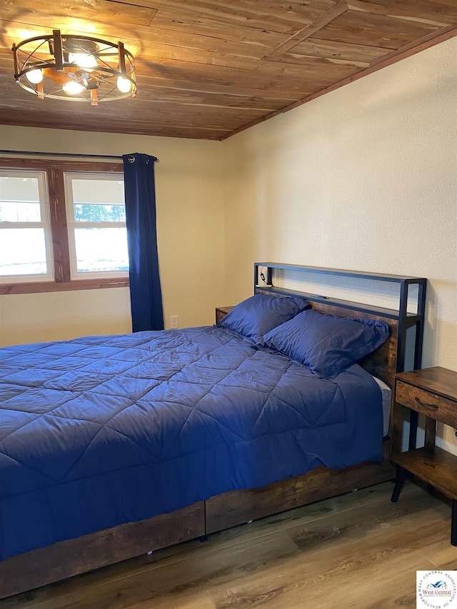 bedroom with wooden ceiling and wood finished floors