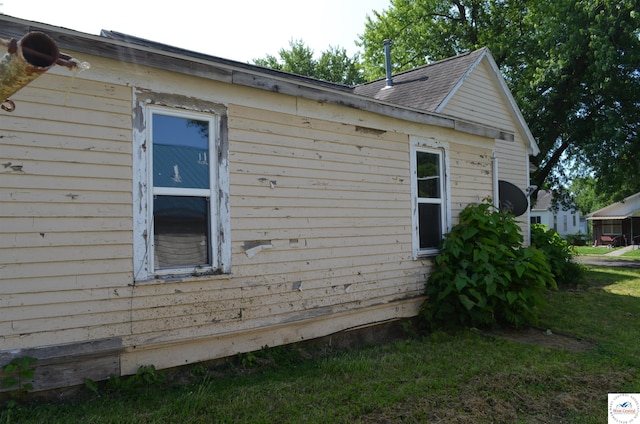 1305 E 14th St, Sedalia, MO 65301 - view of home's exterior with roof with shingles
