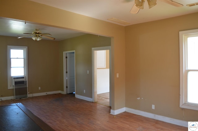 1305 E 14th St, Sedalia, MO 65301 - empty room with ceiling fan, wood finished floors, cooling unit, and baseboards