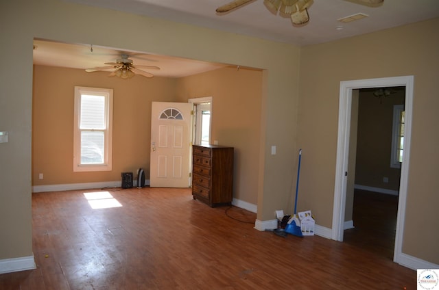 1305 E 14th St, Sedalia, MO 65301 - unfurnished room with a ceiling fan, wood finished floors, and baseboards