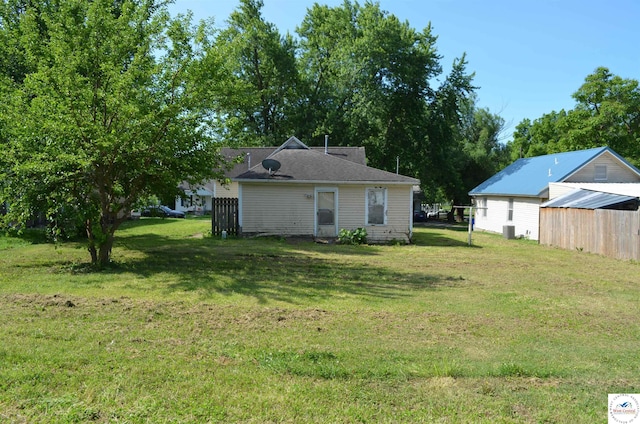 1305 E 14th St, Sedalia, MO 65301 - view of grassy yard with cooling unit