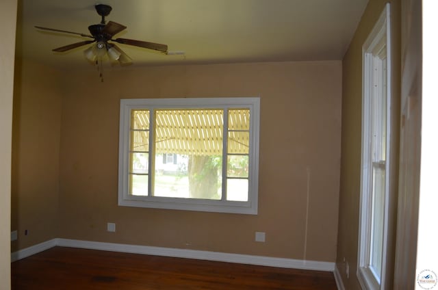 1305 E 14th St, Sedalia, MO 65301 - unfurnished room with dark wood finished floors, baseboards, and a ceiling fan