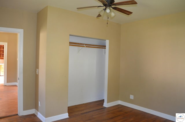 1305 E 14th St, Sedalia, MO 65301 - unfurnished bedroom with wood finished floors, a closet, and baseboards