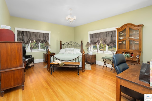 1114 W Broadway Blvd, Sedalia, MO 65301 - bedroom with an inviting chandelier, baseboards, and light wood-type flooring