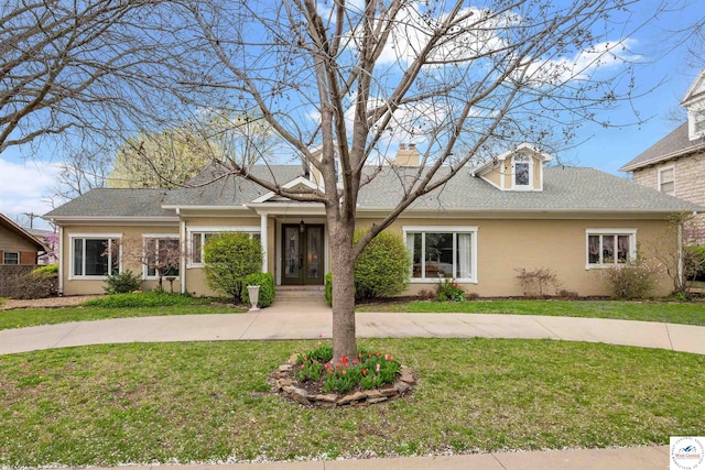 1114 W Broadway Blvd, Sedalia, MO 65301 - view of front facade featuring a front yard, a shingled roof, a chimney, stucco siding, and french doors