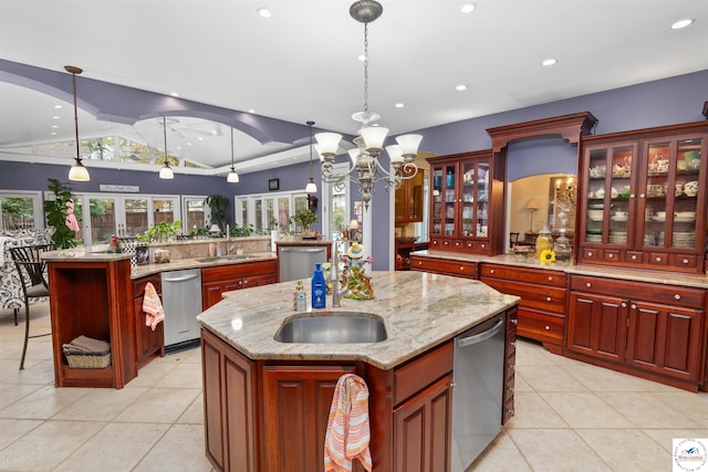 kitchen featuring lofted ceiling, a kitchen island with sink, stainless steel dishwasher, and a sink