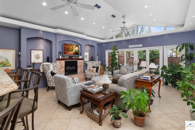 living room featuring recessed lighting, a premium fireplace, light tile patterned floors, a ceiling fan, and vaulted ceiling