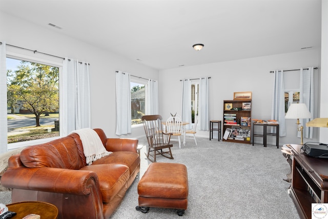 living room with visible vents, plenty of natural light, carpet flooring, and baseboards