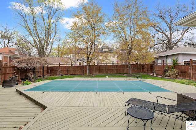 view of pool featuring a deck, a fenced in pool, and a fenced backyard