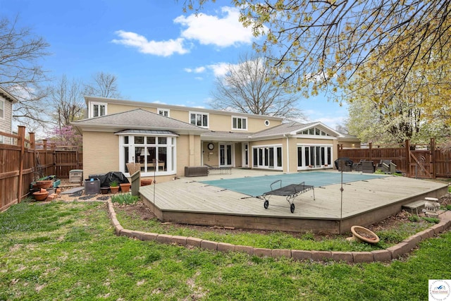 1114 W Broadway Blvd, Sedalia, MO 65301 - back of house with a wooden deck, a yard, french doors, and a fenced backyard