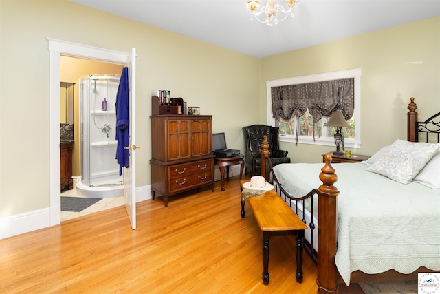 bedroom featuring connected bathroom, baseboards, a chandelier, and light wood-type flooring
