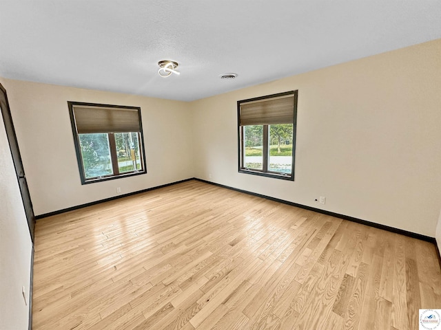 29125 Westwood Ave, Warsaw, MO 65355 - unfurnished room featuring visible vents, light wood-style flooring, and baseboards