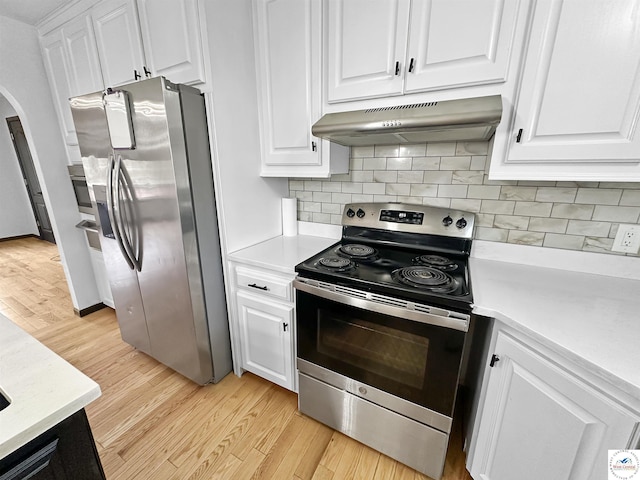 29125 Westwood Ave, Warsaw, MO 65355 - kitchen featuring appliances with stainless steel finishes, light countertops, arched walkways, and under cabinet range hood