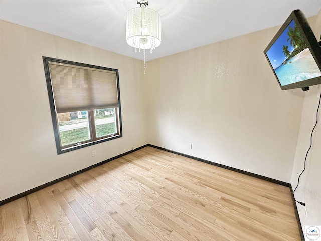 29125 Westwood Ave, Warsaw, MO 65355 - empty room featuring a chandelier, baseboards, and light wood-style flooring