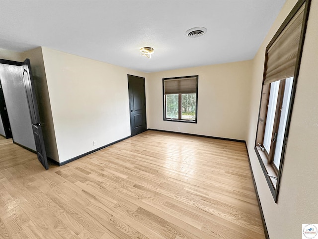 29125 Westwood Ave, Warsaw, MO 65355 - unfurnished bedroom with visible vents, baseboards, and light wood-style floors