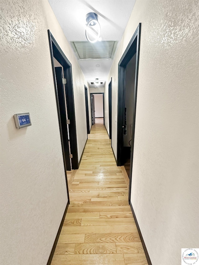 29125 Westwood Ave, Warsaw, MO 65355 - corridor featuring visible vents, a textured wall, and light wood finished floors
