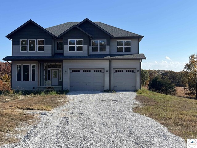 19166 Brockman Ave, Cole Camp, MO 65325 - view of front of house featuring a porch, driveway, a garage, and roof with shingles