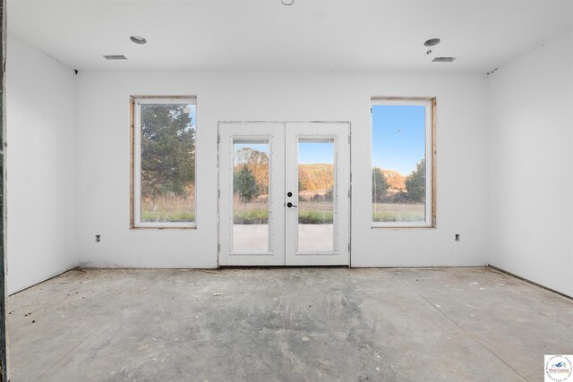 19166 Brockman Ave, Cole Camp, MO 65325 - unfurnished room featuring a wealth of natural light, visible vents, and french doors
