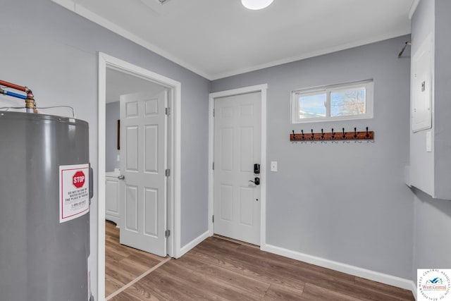 707 E 11th St, Sedalia, MO 65301 - entryway with wood finished floors, electric water heater, electric panel, and baseboards