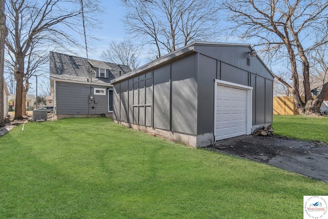 707 E 11th St, Sedalia, MO 65301 - view of outdoor structure with an outbuilding, fence, central air condition unit, and aphalt driveway