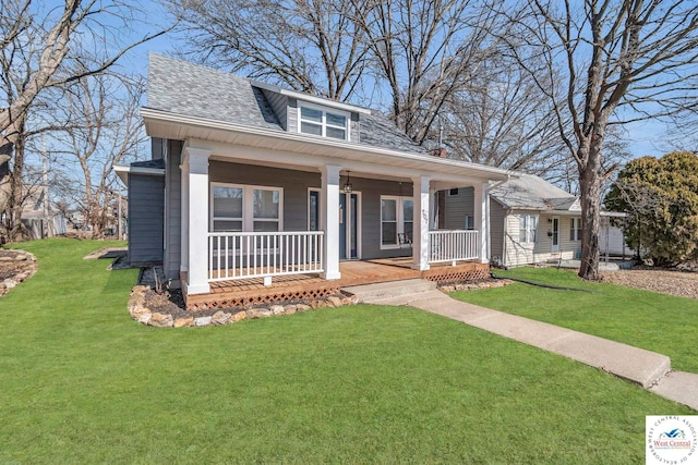 707 E 11th St, Sedalia, MO 65301 - bungalow-style home with a porch, a front yard, and a shingled roof