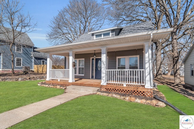 707 E 11th St, Sedalia, MO 65301 - bungalow-style house featuring roof with shingles, covered porch, and a front yard