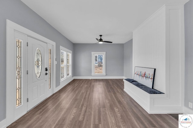 707 E 11th St, Sedalia, MO 65301 - entrance foyer with wood finished floors, a ceiling fan, and baseboards