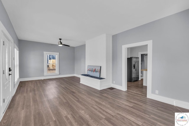 707 E 11th St, Sedalia, MO 65301 - unfurnished living room featuring baseboards, wood finished floors, and ceiling fan