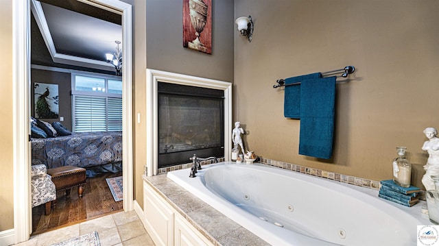 4517 NE Fairway Homes Dr, Lees Summit, MO 64064 - ensuite bathroom with a jetted tub, ornamental molding, and a glass covered fireplace