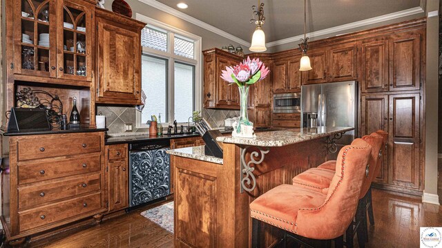 4517 NE Fairway Homes Dr, Lees Summit, MO 64064 - kitchen featuring appliances with stainless steel finishes, a kitchen island, dark wood finished floors, crown molding, and tasteful backsplash