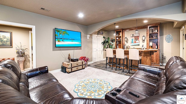 4517 NE Fairway Homes Dr, Lees Summit, MO 64064 - living room featuring arched walkways, bar with sink, recessed lighting, and dark colored carpet
