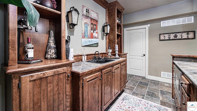 4517 NE Fairway Homes Dr, Lees Summit, MO 64064 - indoor bar featuring dark stone finish floors and baseboards