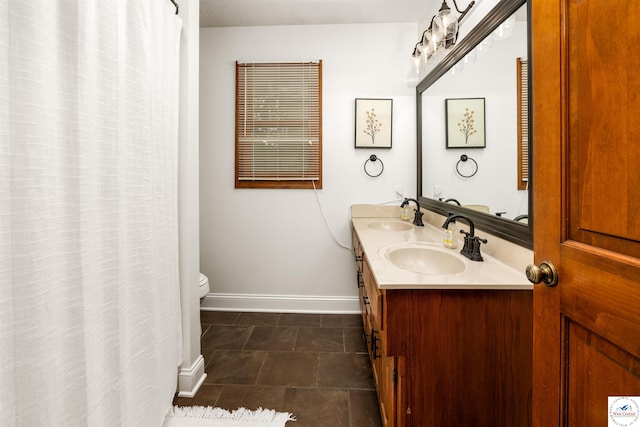 2105 Stonewood Cir, Sedalia, MO 65301 - bathroom featuring double vanity and toilet